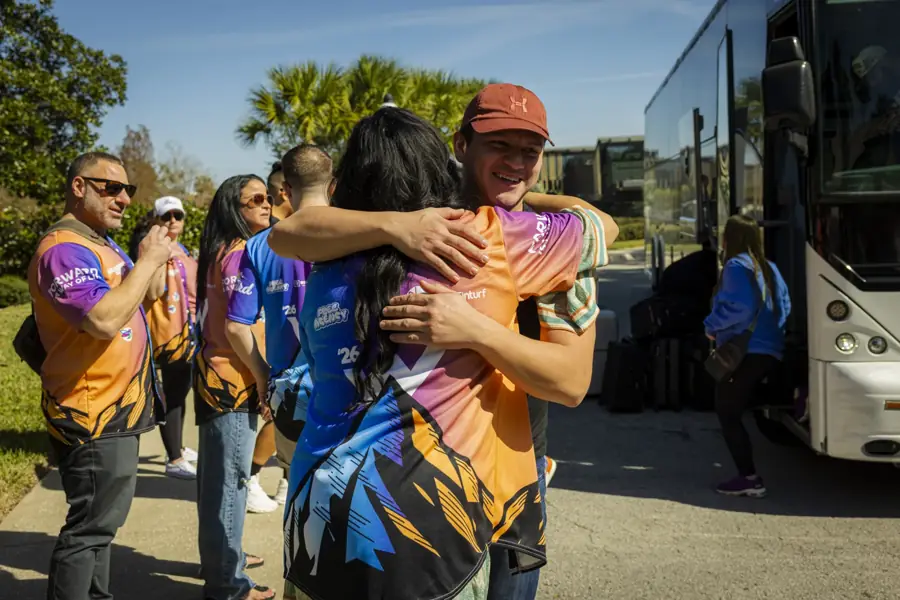 Off the bus, into a hug